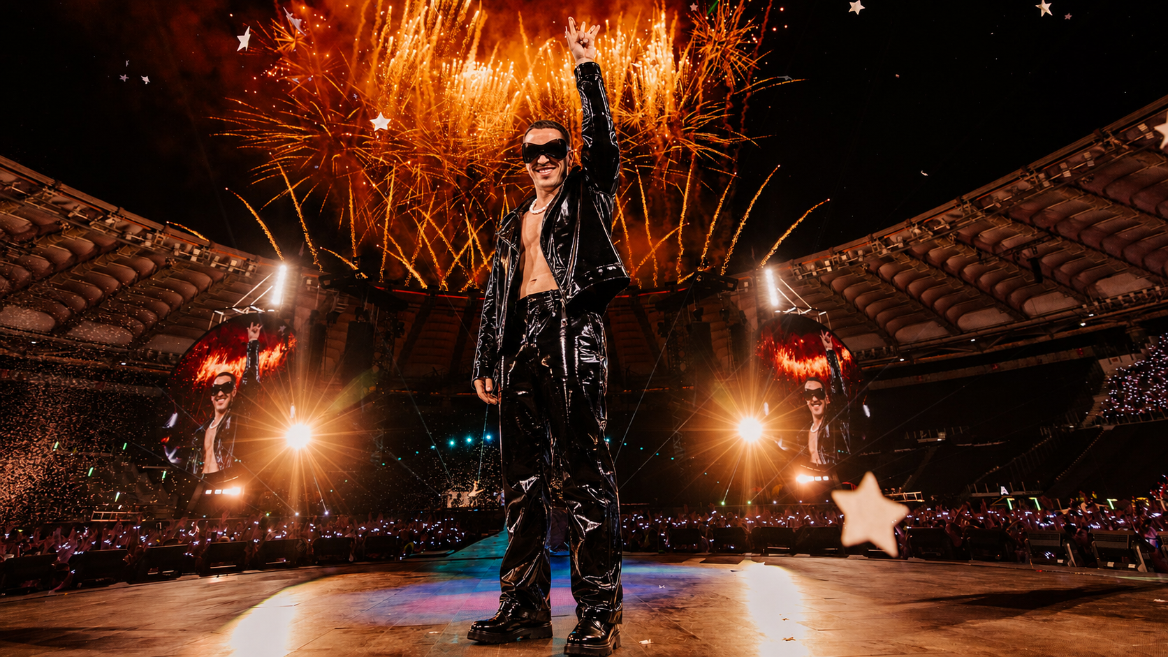 Don Papi on stage with fireworks at a sold-out stadium show
